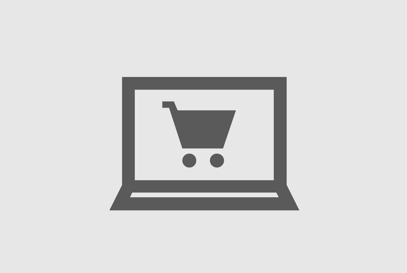 Un ordinateur portable avec un symbole de chariot sur l'écran, représentant les achats en ligne.