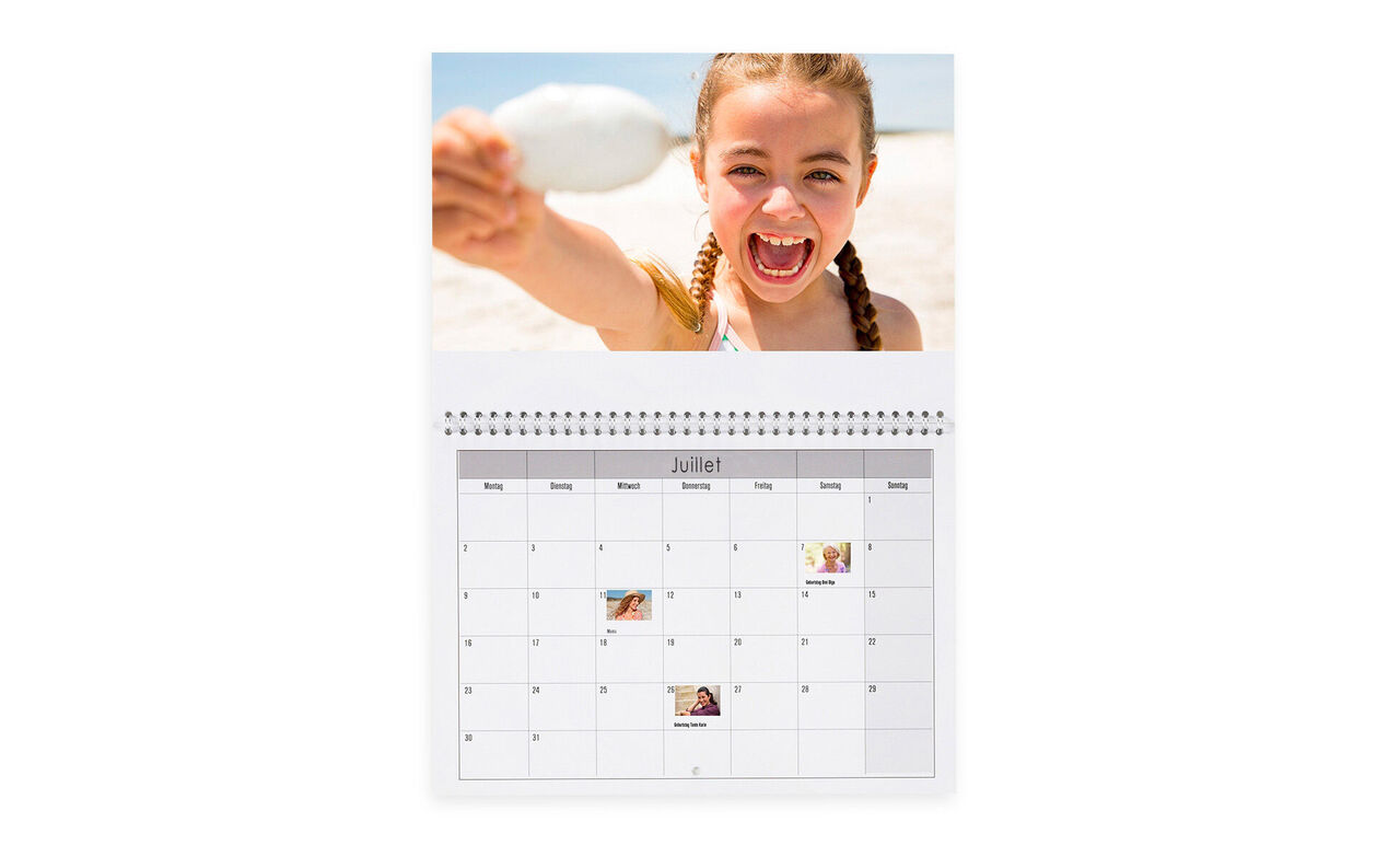 Une fille tient une coquille sur la plage en souriant, avec un calendrier de juillet en arrière-plan.