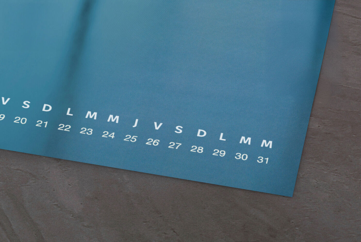 Un beau calendrier turquoise foncé avec chiffres et jours de la semaine.