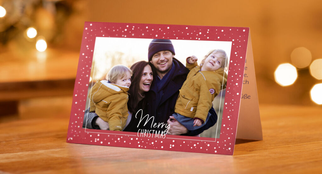 Une carte de Noël joyeuse avec un message chaleureux et deux enfants souriants en manteaux d'hiver.
