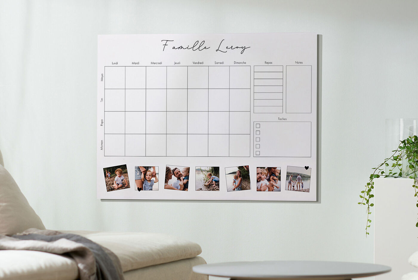 Un texte mural avec un calendrier familial et des images, accroché au mur